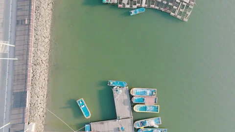 7.a dock in a small town, and small boats Stockbeeldmateriaal 303523163