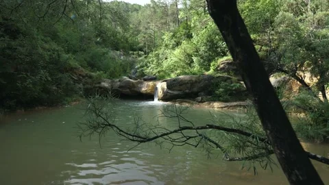 7 shots of a small waterfall and its beautiful stream surrounded by nature m Stock Footage 134642185