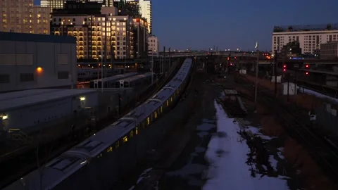 The  #7 train exiting Hunters Point Station during blue hour Stock Footage 160015781