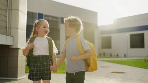 7-Year-Old Children, Boy And Girl, Walking In Schoolyard In September, Students Stock Footage 249021900