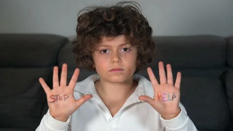 7 year old kid alone with stop and help written on his hands.  Abuse and domesti Stock Footage 170252951