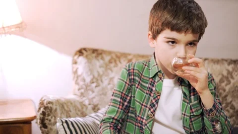 7 years old boy is gargling with herbal decoction Stock-Footage 101704443