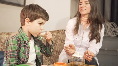 7 years old boy is gargling with herbal decoction, female doctor learning him Stock Footage