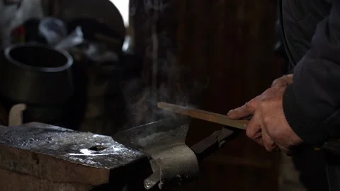7/10 Blacksmith Forging Hits Metal Iron with Hummer In Workshop Stock Footage 233995648