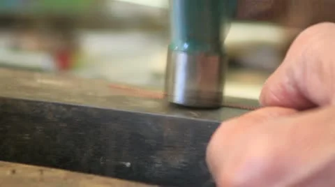 739 banging a metal chord with a green hammer Stock Footage