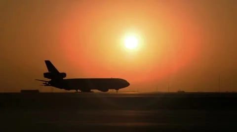 A 747 jumbo jet taxis down runway in the sunset. Stock Footage