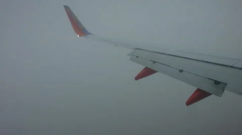 747 wing going through clouds to land at denver Stock Footage 46015903