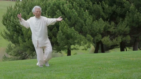 78 Years Old Asian Female Elderly Senior Practice Taichi Outdoors Stock Footage