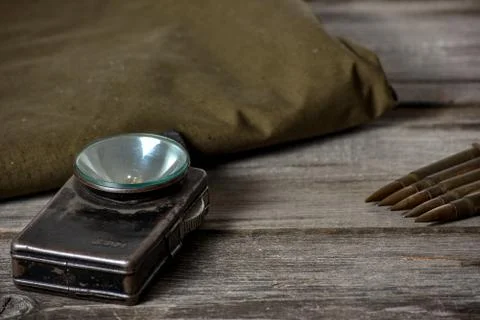7,92 x 57 - rustic ammos, poncho and old flashlight lies on the wooden backgr Stock Photos