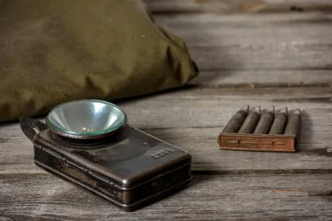 7,92 x 57 - rustic ammos, poncho and old flashlight lies on the wooden backgr Stock Photos