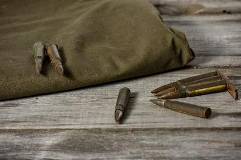 7,92 x 57 - rustic ammos and poncho lies on the wooden background Stock Photos