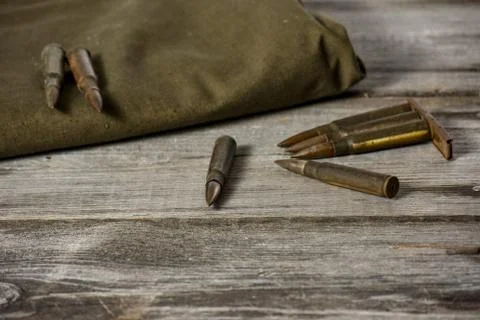 7,92 x 57 - rustic ammos and poncho lies on the wooden background Stock Photos
