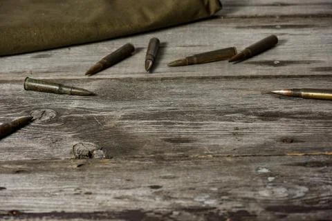 7,92 x 57 - rustic ammos and poncho lies on the wooden background Stock Photos