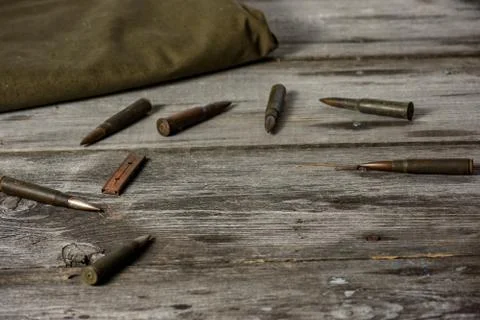 7,92 x 57 - rustic ammos and poncho lies on the wooden background Stock Photos