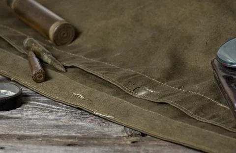 7,92 x 57 - rustic ammos, poncho and old flashlight lies on the wooden backgr Stock Photos