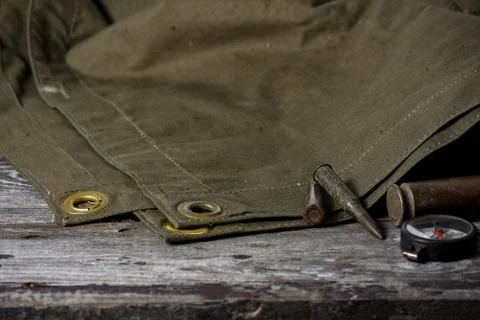 7,92 x 57 - rustic ammos, poncho and old flashlight lies on the wooden backgr Stock Photos