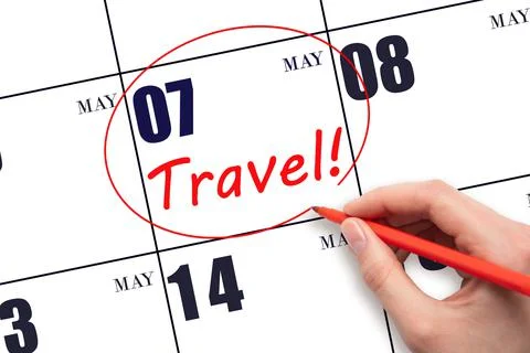 7th day of May. Hand drawing a red circle and writing the text TRAVEL on the  Stock Photos