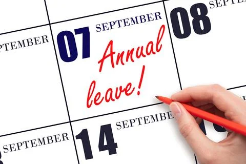 7th day of September. Hand writing the text ANNUAL LEAVE and drawing the sun  Stock Photos