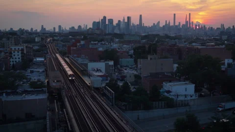 8-15-26, Queens, NY, USA - sunset aerial shot of elevated train Jackson Heights Stock Footage 342306769