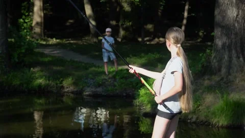 Blonde Young American Girl Fisherman is Fishing on the Forest Lake