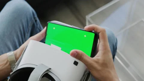 8 Man Using Smartphone With Goggles For Virtual Reality Game Stock Footage 148282981