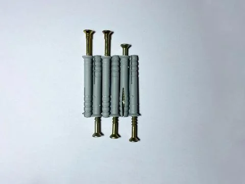8 mm dowels with self-tapping screws on a white insulated background Stock Photos