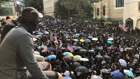 8 Sep 2019 Man With face covered in front. Crowd marching to the US consulate. Stock Footage 115706093