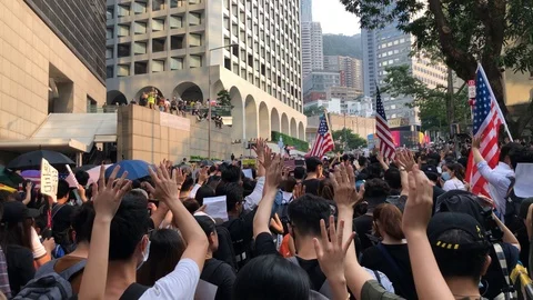 8 Sep 2019  Protesters holding US flags. 5 fingers for 5 demands.  Stand with HK Stock Footage 115706349