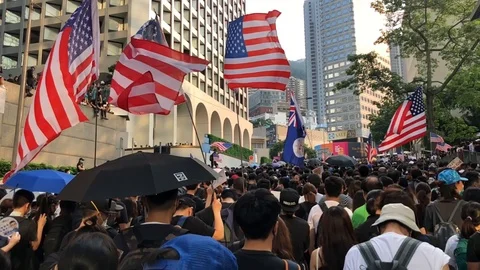 8 Sep 2019  Protesters waving US and HK Flag, marching to US consulate Stock Footage 115706512