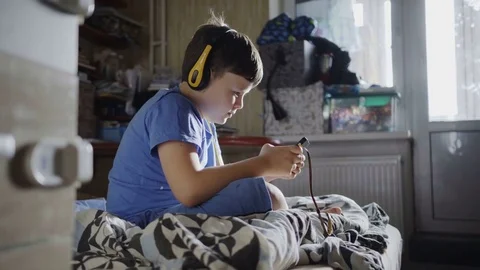 8 years caucasian type boy playing the on the smartphone at home. Stock-Footage 82281111