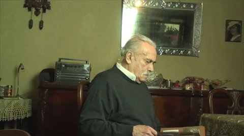 80 Years Old Man, Looking In An Photo Album, Memories, Family, Nostalgic, Tilt Stock Footage 39835571