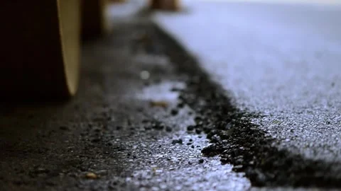 On 8/07/2023, glimpse modernization as machines lay fresh asphalt, reshapin.. Stock-Footage 247876798