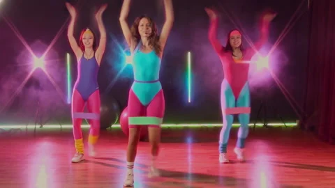80s Instructor Demonstrating Cardio Routine at Group Class for Fitness Video Stock Footage 328368630