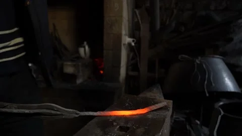 8/10 Blacksmith Forging Hits Metal Iron with Hummer In Workshop Stock Footage 233995708