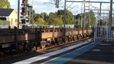 8.1.25: Freight Train Passing Through Railway Station at Speed Stock Footage 314274746
