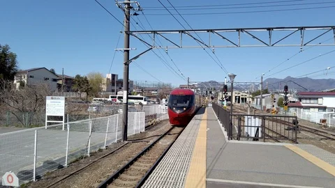 The 8500 series red colored train Fujisan view express arriving to Mt. FUJI Stock Footage 124331029