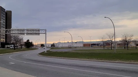 8K 24fps 4320p - Freeway exit ramp with single vehicle and large mall in the Video stock 129787393