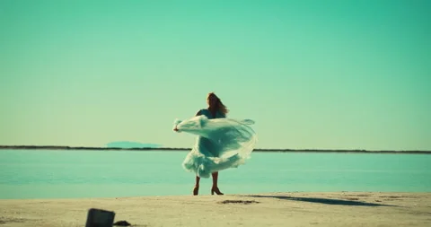 8K • Blonde in blue gown spins 720 degrees • Salt Flats, UT • Slomo Vídeo Stock 284992653