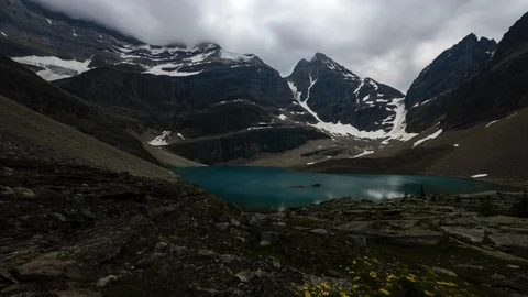 8K blue mountain lake in a cloudy valley Stock Footage 107962473