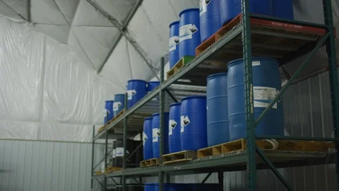 8K Chemical Storage Facility Pan Across Blue Drums Stock-Footage 96249349