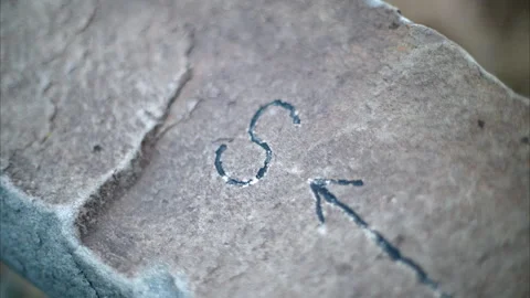 8K Close-up of Carved Arrow in Stone Pointing South with Shallow Depth of Field Stock Footage 304965152