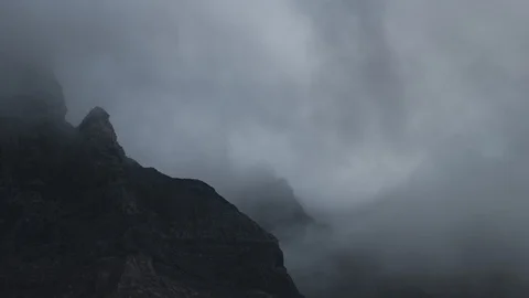 8K Close up of clouds flowing around mountain peaks Video stock 107967614
