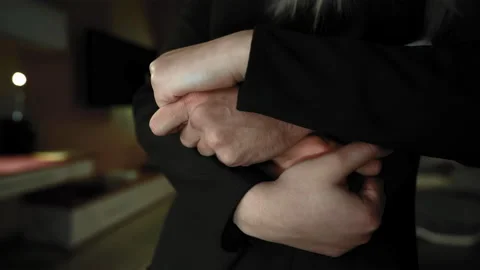 8K Close-up of the hands of a guy hugging a girl standing from behind. Stock Footage 196234644