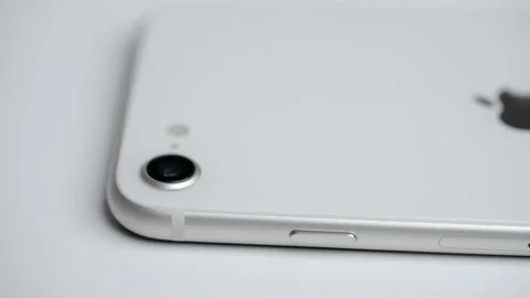 8k closeup video Apple Iphone SE camera spinning on white background Video stock 232746069