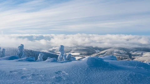8K Clouds rolling over the peak of mountains and sometimes sun shows up Stock Footage 108060925