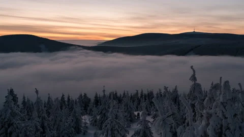 8K Colorfull clouds, low clouds and frozen landscape before sunrise Stock Footage 255610772