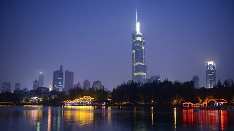 8K Day to Night Time Lapse of Nanjing Skyline People Entertain on Boats on Lake Video stock 106622995