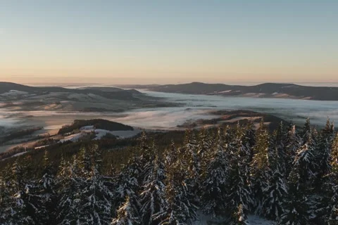 8K Lazy low clouds rolling over the villages in sunrise colours Stock Footage 256144456