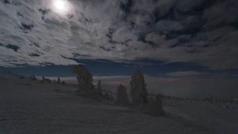 8K Midnight clouds illuminated by moon and low clouds rolling in the valley Stock Footage 255845955