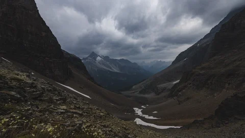 8K moody time lapse of dark clouds in moutain valley Stock Footage 107961336